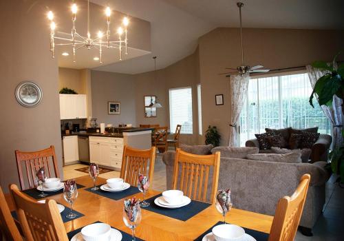 a dining room and living room with a table and chairs at Four-Bedroom Pool Home Kissimmee in Orlando