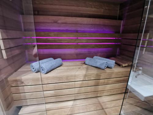 a sauna with two towels on a wooden floor at Jacuzzi Apartments in Krakow