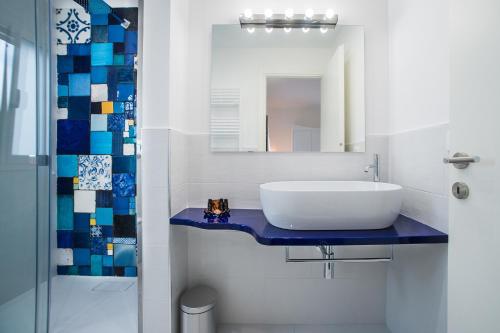 a bathroom with a sink and a mirror at COCCIU D’AMURI in Castellammare del Golfo