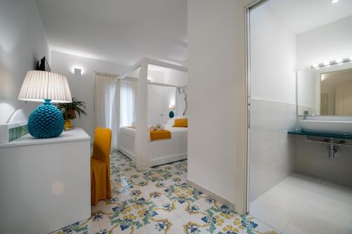 a bathroom with a shower and a sink and a bedroom at COCCIU D’AMURI in Castellammare del Golfo