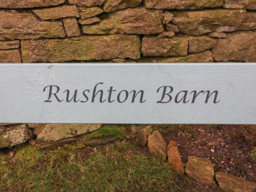 a sign that reads revision ban on a stone wall at Rushton Barn in Settle