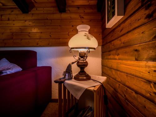 a lamp sitting on a table in a room at Appartement cosy au centre de Grimentz in Grimentz