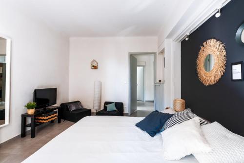 カンヌにあるPlace to be - Terrasse Bord de mer Croisetteの白いベッドと黒い壁のベッドルーム1室