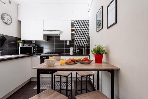 a kitchen with a table with a bowl of fruit on it at Place to beach - Terrasse Bord de mer Croisette in Cannes