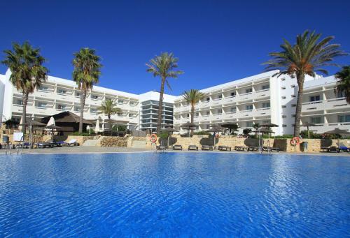 a large swimming pool in front of a hotel at Garbí Costa Luz in Conil de la Frontera