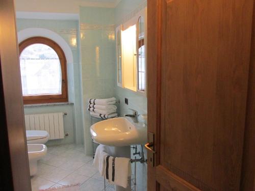 a bathroom with a sink and a toilet at Casa Bamby in Cogolo