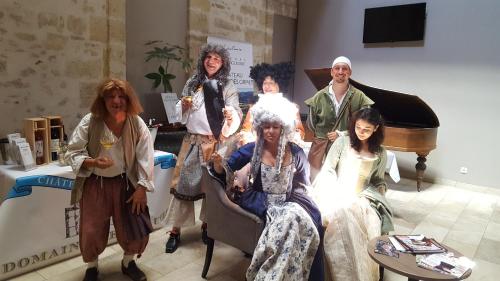 a group of people dressed in costumes posing for a picture at Le Grand Hôtel Molière in Pézenas