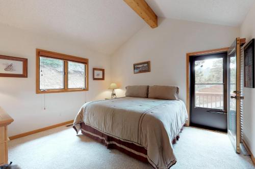 a bedroom with a bed and a large window at Mountain Splendor in Estes Park