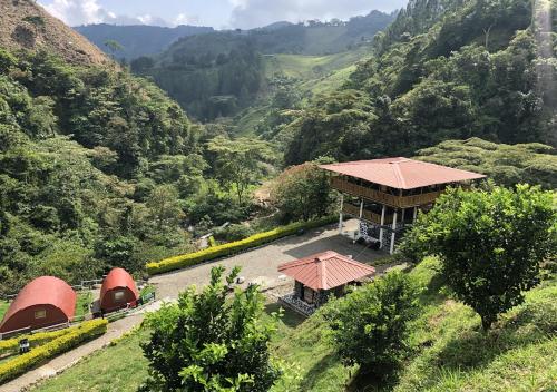 an aerial view of a building with a view of a valley at Termales el Escondite in Florencia