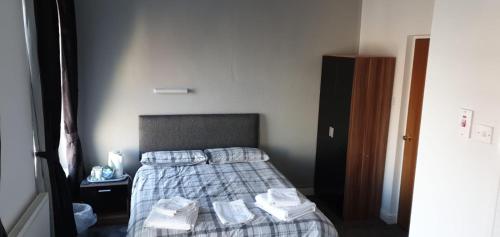 A bed or beds in a room at The Lodge Guest Accommodation 