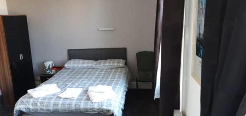 A bed or beds in a room at The Lodge Guest Accommodation 