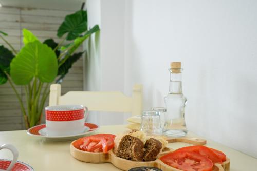 a table with a plate of food and a bottle at Hermes Beach Front in Stalos