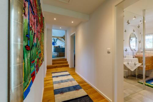 a hallway with a large colorful painting on the wall at La Felicita 7 in Schluchsee