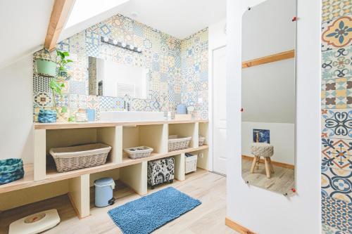 uma casa de banho com um lavatório e um espelho em Chambres d'Hôtes les Colombes em Montmort-Lucy