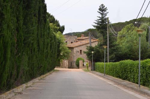 an empty road in front of a building at VILLAS COSETTE Molí d'en Tarrés in Santa Cristina d'Aro
