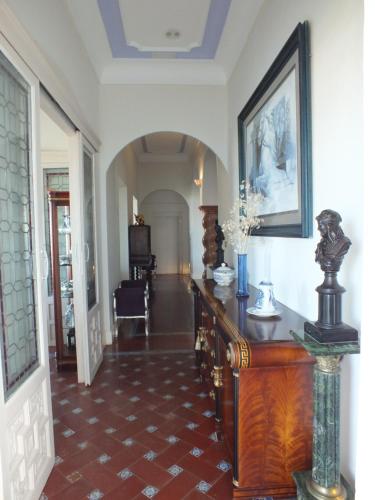 a hallway of a home with a table and a room at Casa Palacio VillaZambra in Ronda