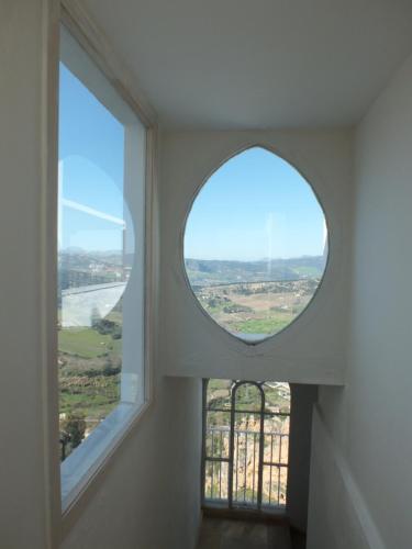 anorthole window in a building with a view at Casa Palacio VillaZambra in Ronda
