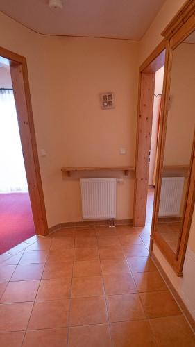 a room with two radiators and a tiled floor at Ferienwohnungen am Kurpark in Roßhaupten