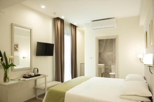 Ένα ή περισσότερα κρεβάτια σε δωμάτιο στο Roseum Boutique Hotel