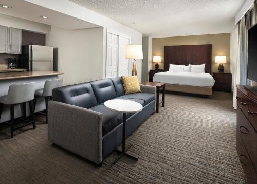 a hotel room with a couch and a bed at Residence Inn by Marriott Seattle/Bellevue in Bellevue