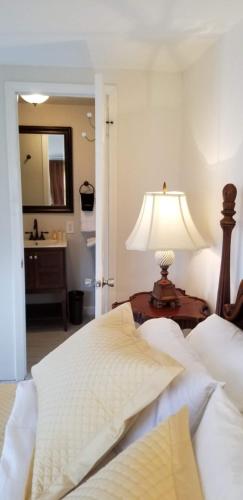 a bedroom with a bed and a table with a lamp at Lily Creek Lodge in Dahlonega