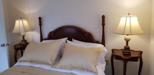 a bedroom with a bed with two lamps on both sides at Lily Creek Lodge in Dahlonega