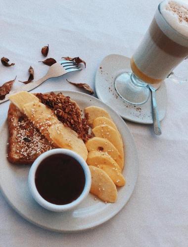 a plate of food with toast and a cup of coffee at Hotel Gala in Puebla