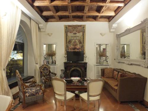 a living room with a couch and a table at Casa Palacio VillaZambra in Ronda