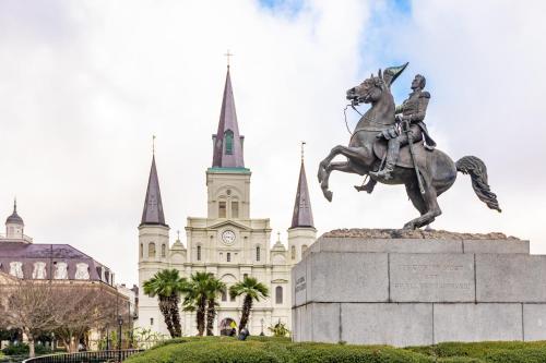 a statue of a man on a horse in front of a building at Hotel de la Monnaie, French Quarter in New Orleans