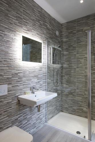 a bathroom with a sink and a shower at Railway Apartments in Nailsworth