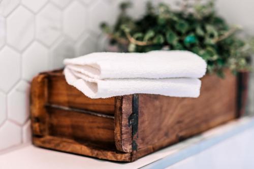 a stack of towels on a wooden box with a plant at West 7 in Zandvoort