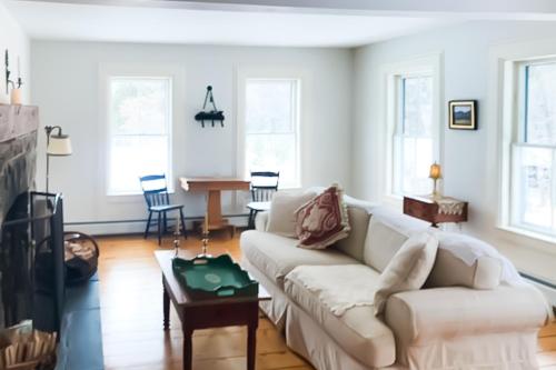 a living room with a white couch and a table at Lincoln Escape in Lincoln