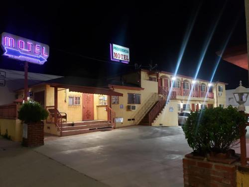 a hotel with a neon sign at night at Providencia Motel in Burbank