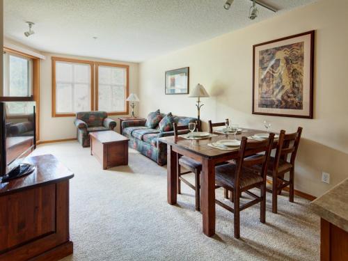 a living room with a table and a couch at Panorama Mountain Resort - Ski Tip / Tamarack Condos in Panorama