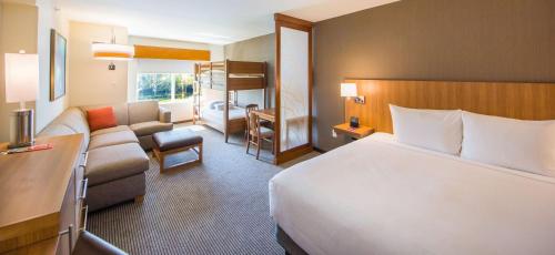 a hotel room with a bed and a couch at Hyatt Place Orlando/Lake Buena Vista in Orlando