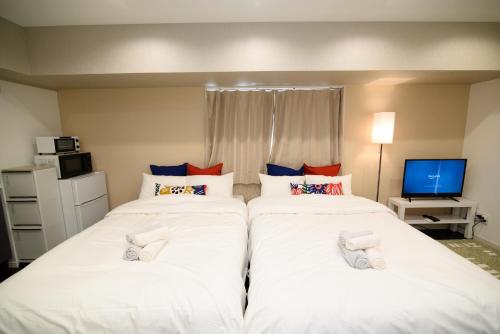 Postel nebo postele na pokoji v ubytování Hotel Central Yokohama