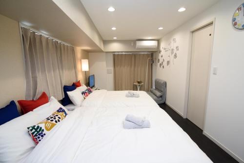 Postel nebo postele na pokoji v ubytování Hotel Central Yokohama