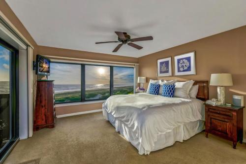 a bedroom with a bed and a large window at Amelia Island Oceanfront 2 Master Suites in Amelia Island