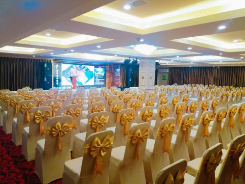 a room with rows of chairs with bows on them at Kings Hotel Dalat in Da Lat