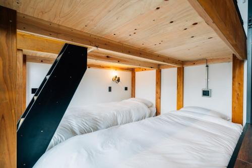 a room with three beds and a slide at ZONK HOTEL Nakasu-Deaibashi in Fukuoka