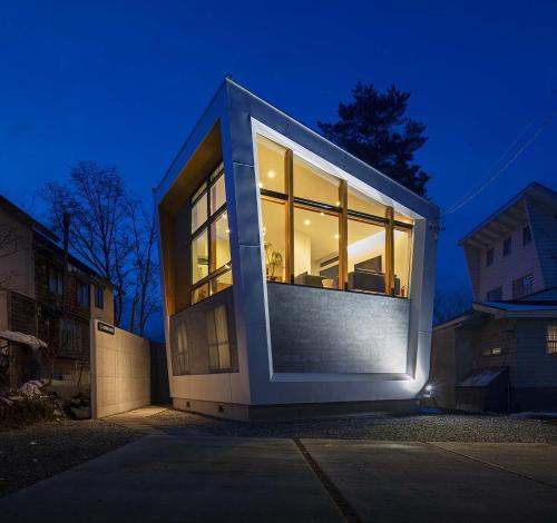 a house with a large window on the side of it at Alpinarc Chalet by Hakuba White Fox Company in Hakuba