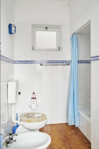 a bathroom with a sink and a toilet and a tub at Captain Pisco's Palheiro - Great Location in Costa Nova