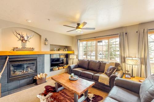 a living room with a couch and a fireplace at Skiscape in Steamboat Springs