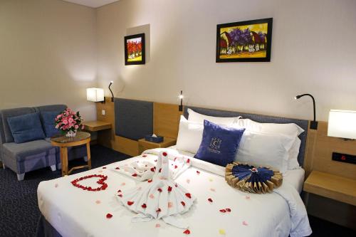 a hotel room with a bed with flowers on it at Ciao SaiGon Hotel & Spa in Ho Chi Minh City