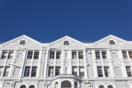 a large white building with a blue sky in the background at Imperial Hotel in Llandudno