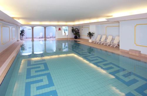 a large swimming pool in a hotel room with a pool at Imperial Hotel in Llandudno