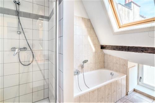 a bathroom with a shower and a bath tub at The Capital Street Lodge in Antwerp