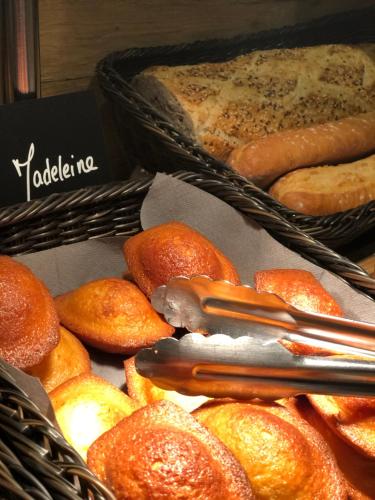 two baskets filled with lots of different types of bread at Kyriad Aix Les Milles - Plan de Campagne in Bouc-Bel-Air