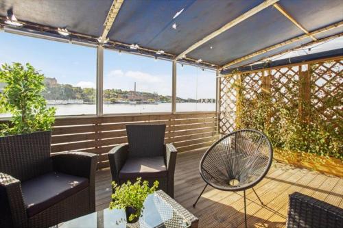 a patio area with chairs and a bench at Mälardrottningen Yacht Hotel & Restaurant in Stockholm