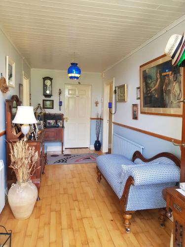 a living room with a couch and a table at Brookvale in Wellingtonbridge